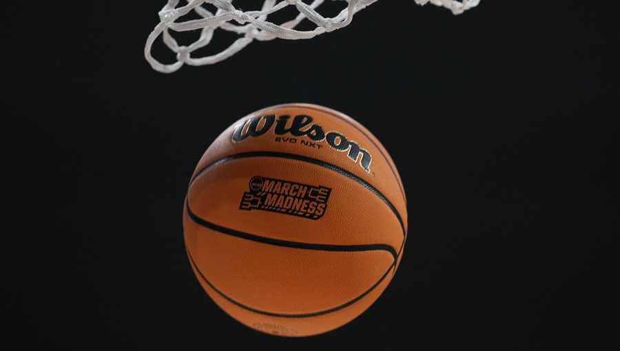 A basketball fall through the hoop during warmups for a first-round college basketball game.